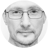 Black and white headshot photo of Eugen Borcan - male, caucasian, short hair, adult in his 40s, wearing glasses with thin rectangular frames.